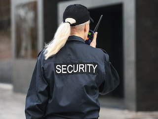 A Security Officer talking into a radio